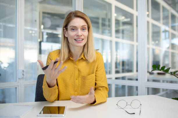 istock Professional woman engaging in a video call in modern office setting 2163075052