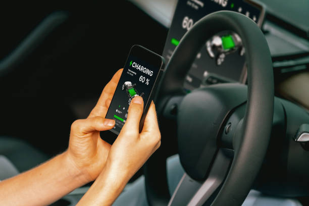 istock Young woman inside the vehicle, checking EV vehicle's application. Exalt 2163075426