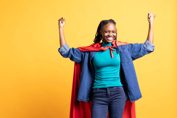 istock Superhero flying with red cape, isolated over studio background 2163076579