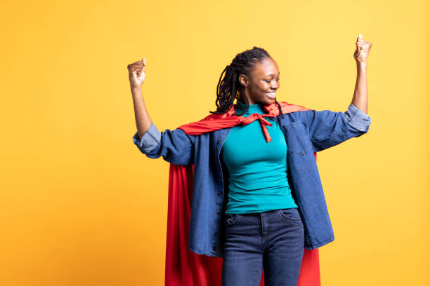 istock Superhero flying with red cape, isolated over studio background 2163076608
