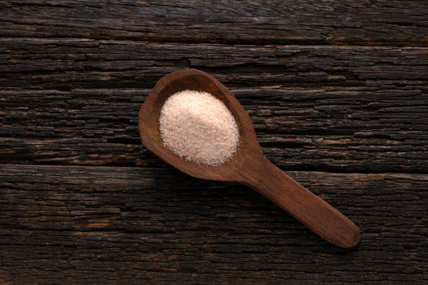 istock Himalayan fine pink salt in spoon - rustic wooden background 2163078828