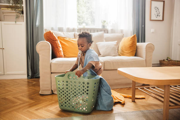 Close-Up Of Clothes In Laundry Basket On White Background