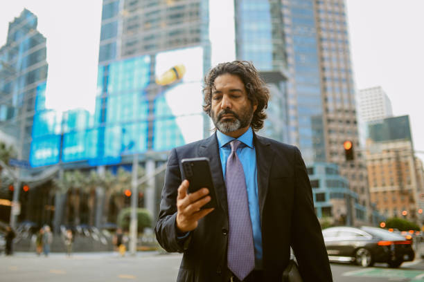 istock Checking messages on the smartphone in Los Angeles Financial District 2163084901
