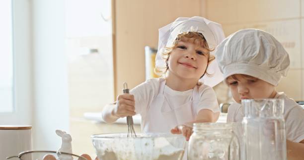 istock Little Chefs in Training: Boys Mixing Batter Together in Slow Motion 2163088370