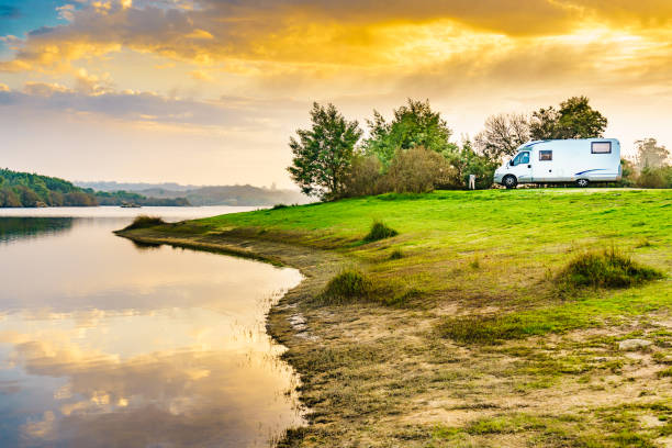 istock Rv caravan on lake shore at sunset. Autumn time. 2163089712