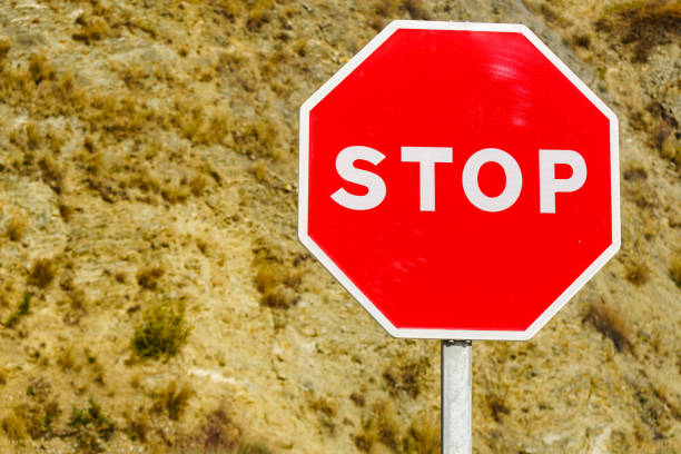 Traffic stop red sign by the road in mountains