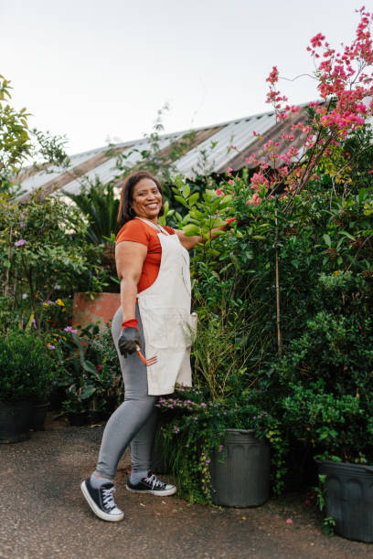 istock Smiling woman working in plant store 2163093245