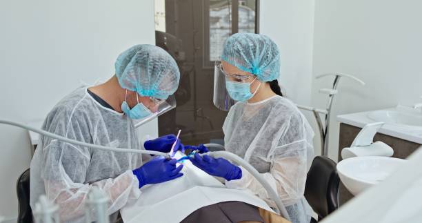 istock Focused Dental Team Performing Procedure on Patient 2163094352