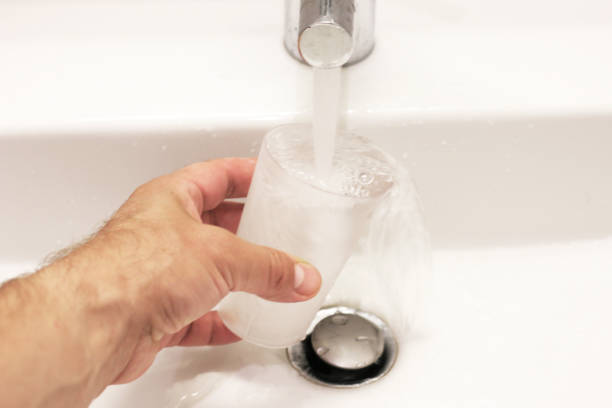 istock Pouring water into a glass. 2163096264