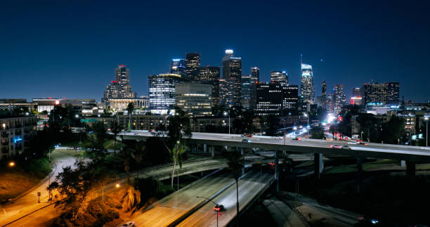 istock Downtown LA Skyline from behind Interstate Highways at Night - Aerial 2163097631