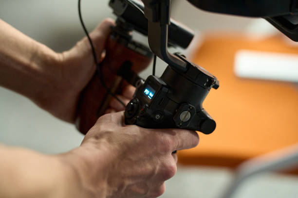 istock Close-Up of Videographer Operating Gimbal Camera 2163113174