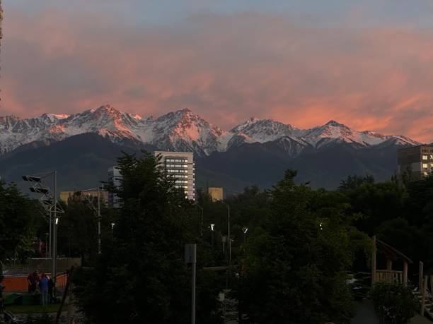 istock Cityscape with Snow-Capped Mountain at Sunset 2163113193