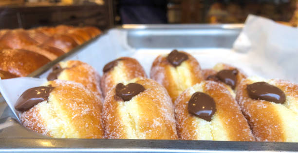 istock Paris, France: Chocolate-Filled Donuts in a Row Bakery Window 2163113622