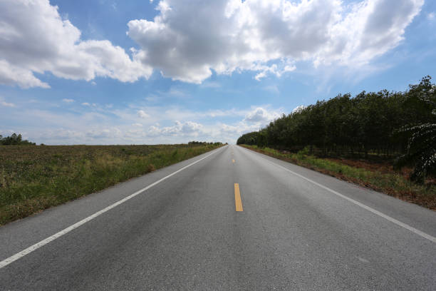 Empty highway road and countryside view on blue sky background. Natural scenery in the countryside of a city in Thailand.