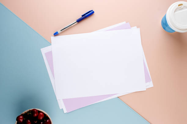 istock Office Setup with Pen, A4 Paper, Coffee Cup, and Cherries on Colorful Background 2163115144