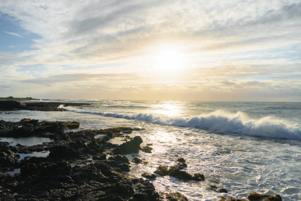 istock Sunset over the ocean, waves crashing on rocky shore 2163121850