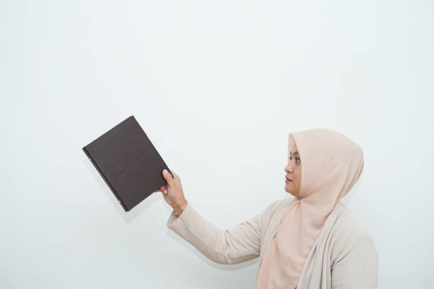 Asian Muslim woman eating dates and resting during fasting at home during Ramadan