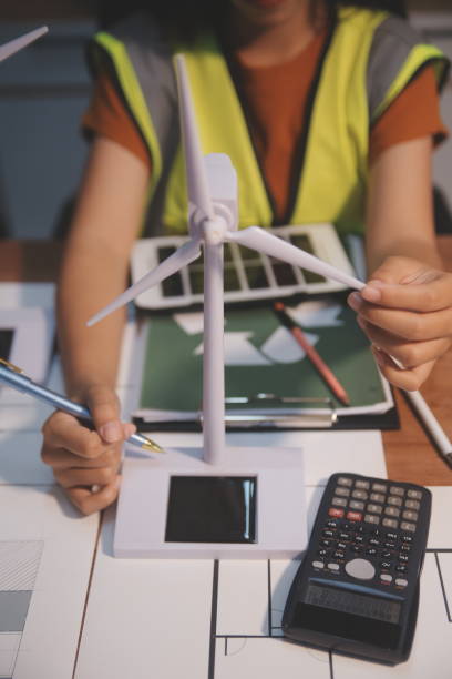 istock Female architect working at home She looked at the blueprint. 2163129013