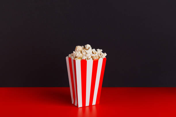 istock Striped box with popcorn on a red and black background 2163130440