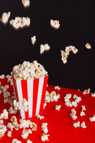 istock Striped box with popcorn on a red and black background 2163130715