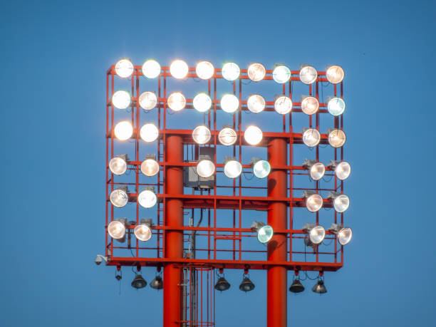 istock A red stadium light tower rises against a clear blue sky. 2163131491