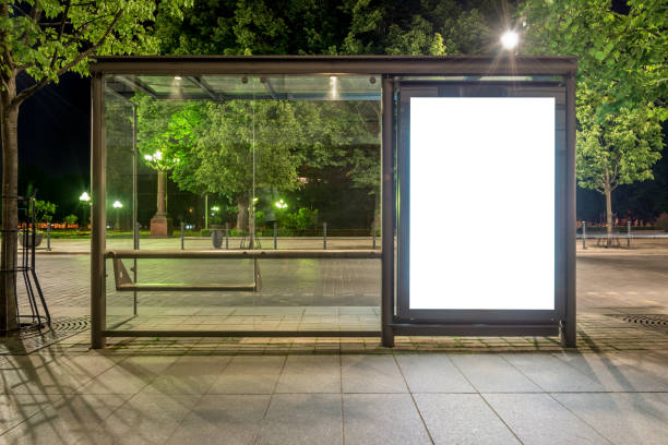 Mockup Of Bus Stop Vertical Billboard In Front Of Empty Street Background At Night Mockup Of Bus Stop Vertical Billboard In Front Of Empty Street Background At Night. Blank Advertising Display In A Park bus shelter stock pictures, royalty-free photos & images