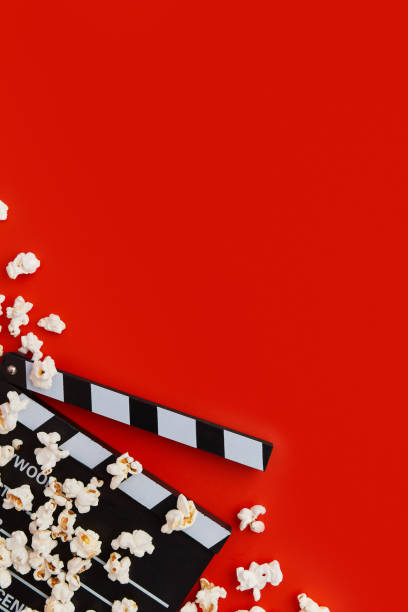 istock Popcorn and clapperboard on a red background. Flat lay, copy space 2163134135