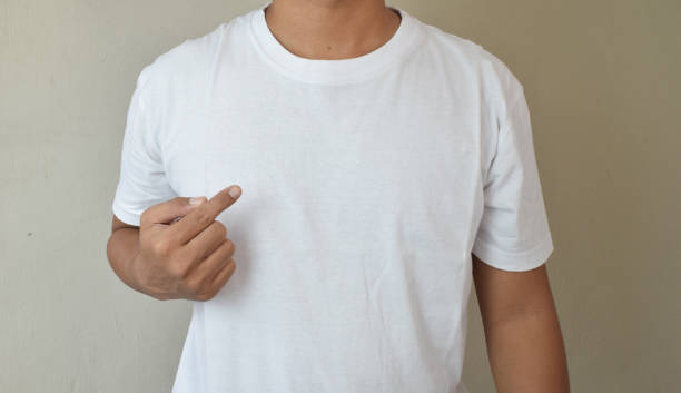 istock Man pointing index finger a copy space on her blank white t-shirt 2163135640