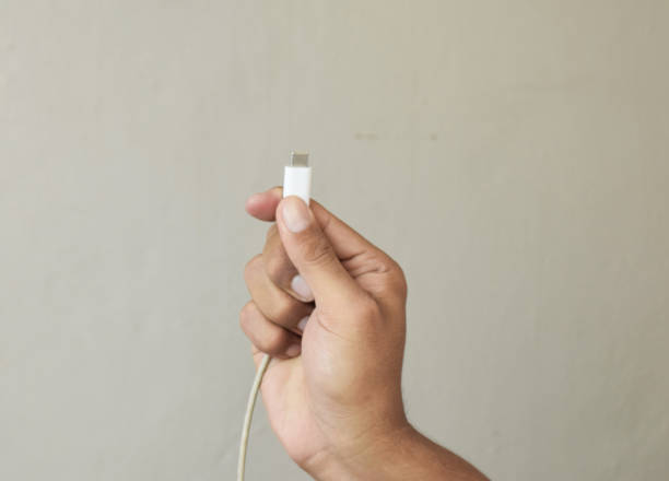 istock Close up Man hands holding usb-c cord 2163135807