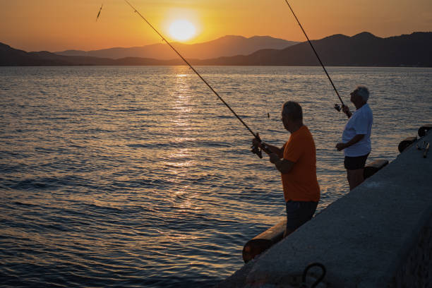 Two men are fishing with a hook