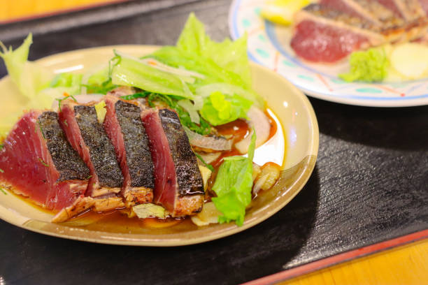 preparing a tuna fillet at the tokyo fishmarket.