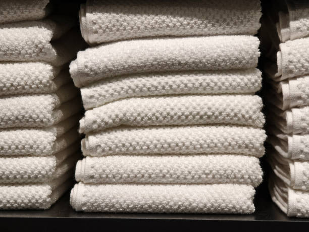 istock A stack of white towels neatly arranged on a black shelf 2163143313