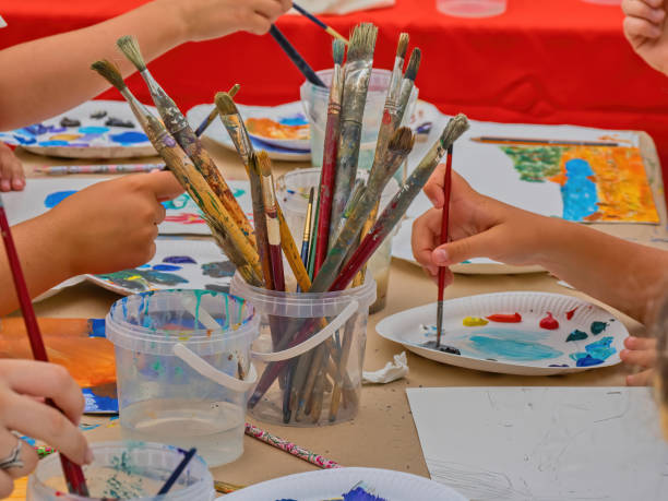 istock Master class of the artist. Mixing colors on a palette during a master class in an art studio. 2163144210