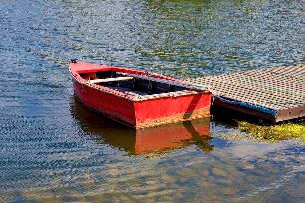 istock Red boat with oars at the pier. 2163144245