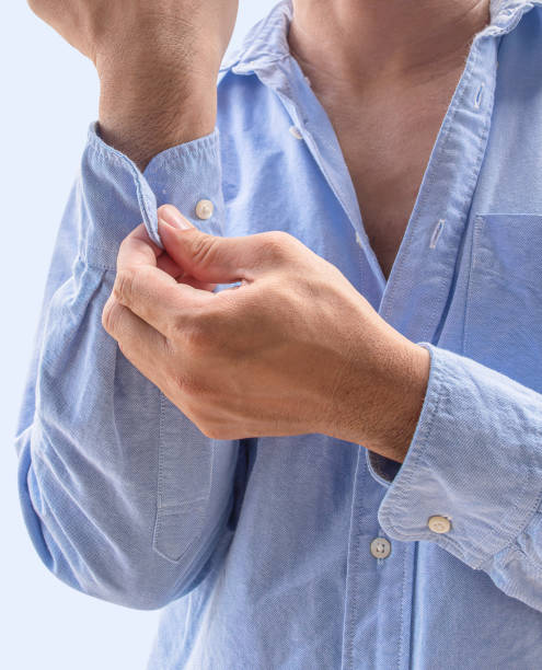istock Man button up the sleeves of a blue shirt 2163145465