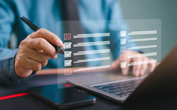 istock Checklist performance concept. Businessman use computer and smartphone application tick online checklist. Check business survey, fill digital poll, data assessment list, questionnaire, evaluate audit 2163146668