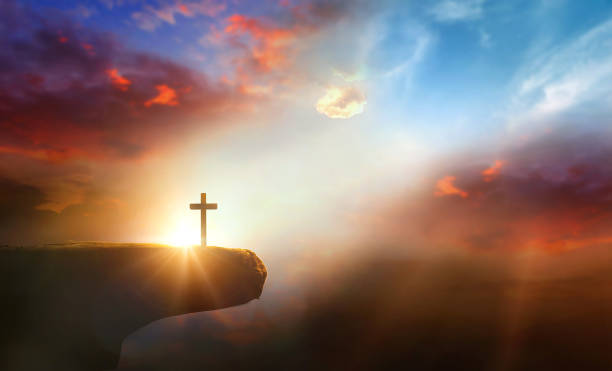 istock Cross on the cliff and sunset sky background. 2163149341