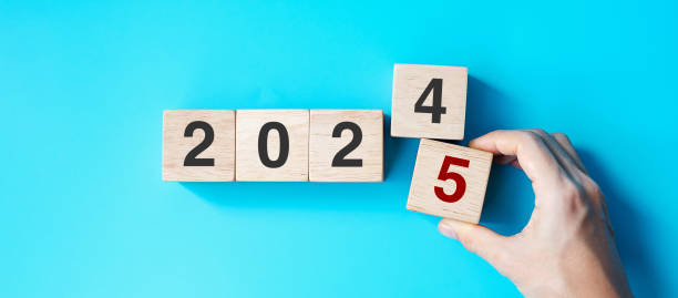 istock hand holding wooden cube block with 2025 text on blue background. Resolution, plan, review, goal, start and New Year holiday concepts 2163150984