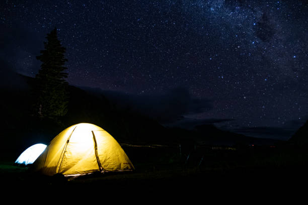 istock Starry Night Sky with Illuminated Tent 2163151257