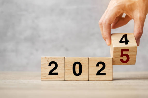 istock hand flipping block 2024 to 2025  text on table. Resolution, strategy, plan, goal, motivation, reboot, business and New Year holiday concepts 2163151355