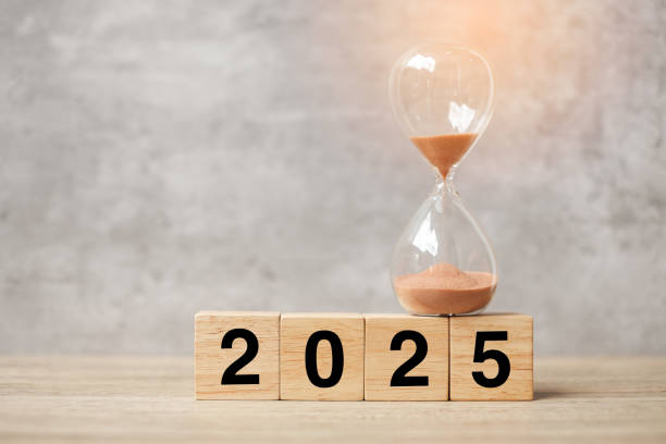 istock 2025  text with hourglass on table. Resolution, time, plan, goal, motivation, reboot, countdown  and New Year holiday concepts 2163151356