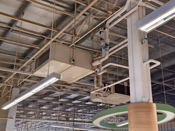 istock Ceiling with ventilation pipes and lights in industrial building 2163153020