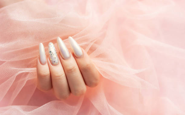 istock Female Hands with beautiful pearl manicure 2163153344