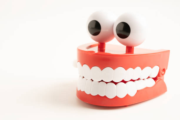 Colorful Plastic Teeth and Tongues Toys on Purple Background
