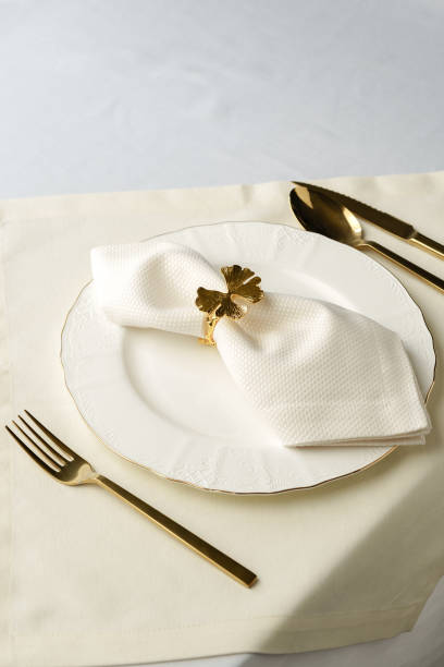 istock Gold Leaf Napkin Ring on White Plate and Placemat 2163157715