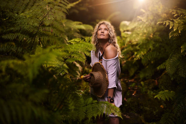istock Pensive woman with a hat among greenery in nature. 2163158669