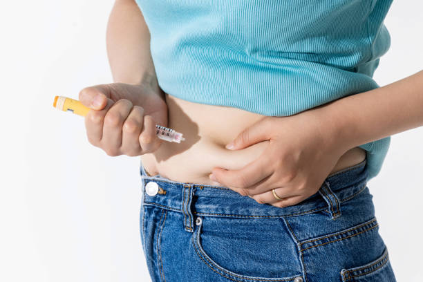 istock injecting self with obesity medication 2163159655