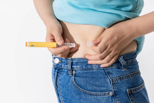 istock injecting self with obesity medication 2163159658