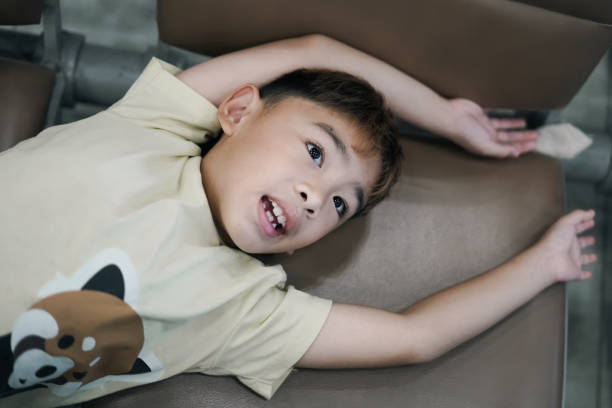 boy sleeping on a chaise longue