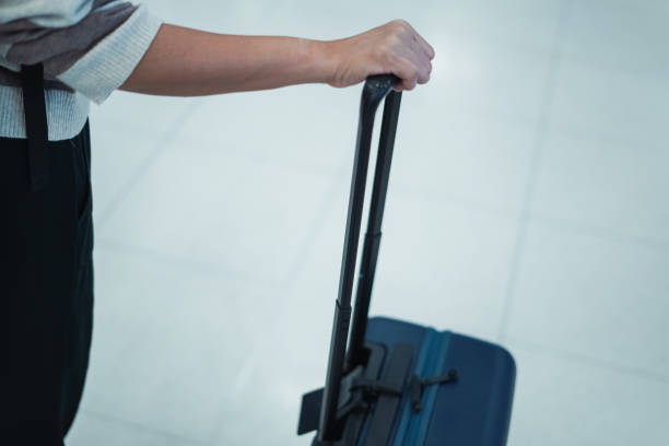 istock Female hand holding a suitcase 2163160640